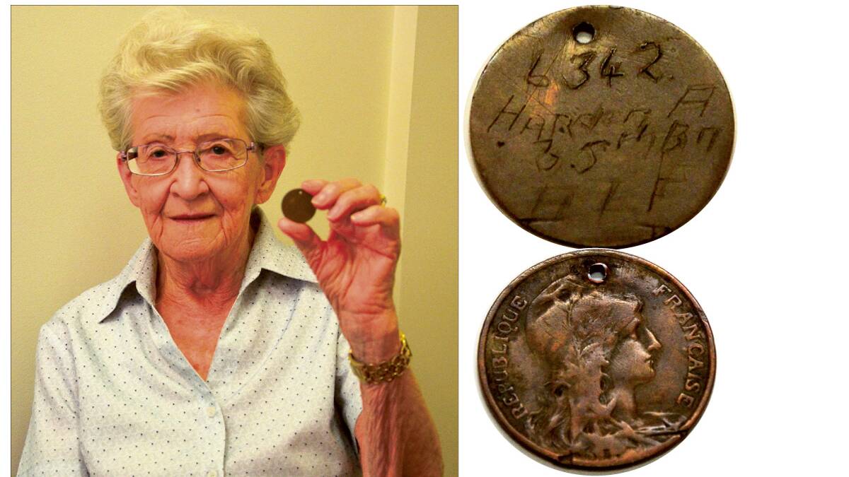 Norma Bell with the French franc she found, with the inscription '6342, Harden A'.