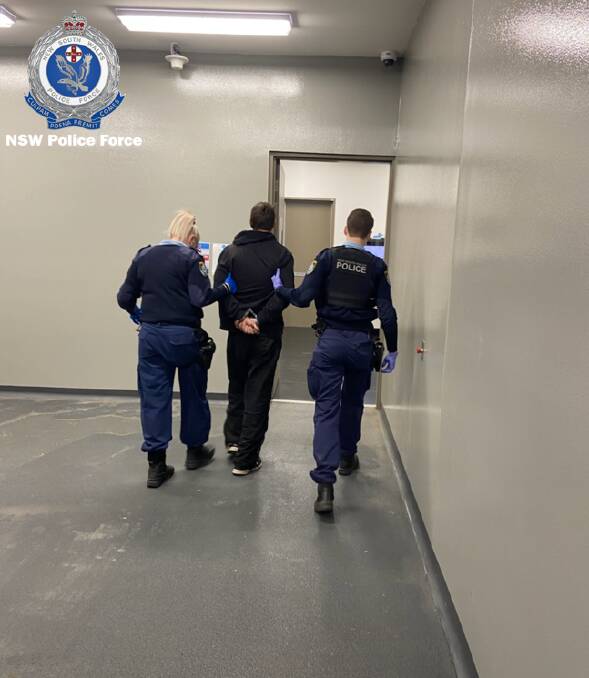 LOCKED UP: Adam Mitchell after his arrest. He has since pleaded guilty to police pursuit, using a vehicle in contravention of a major defect notice and three counts of unlawful possession of number plates. 
