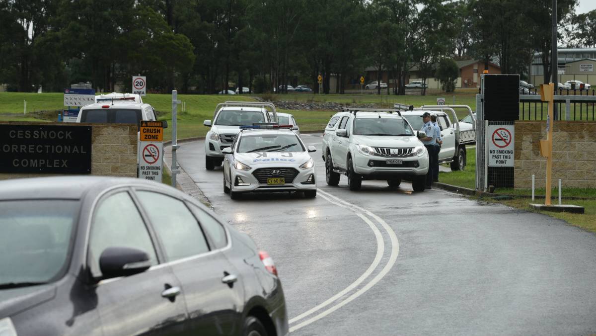 DISORDER: Police outside Cessnock Correctional Centre on the day of the riot in April. Police this week charged 21 men with rioting, participating in a criminal group and damaging property. Picture: Jonathan Carroll 