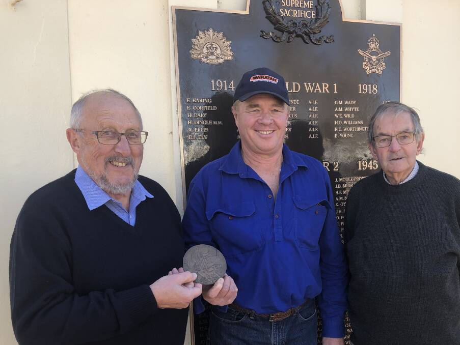 RETURNED: Paul King (centre) donates the 'dead man's penny' medallion for Alan McGregor Whyte to Griffith War Memorial Museum's Theo Bollen and chairman Garry Smellie. Picture: Declan Rurenga