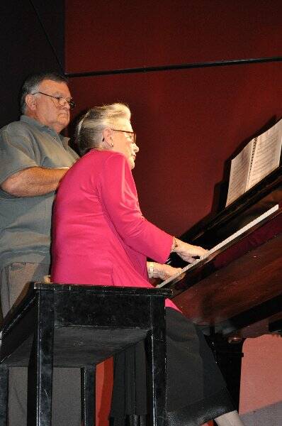 A FAMILIAR ROLE: Mrs. Hill accompanying the Cantata Choir at the ceremony, assisted by Ron Jackson.