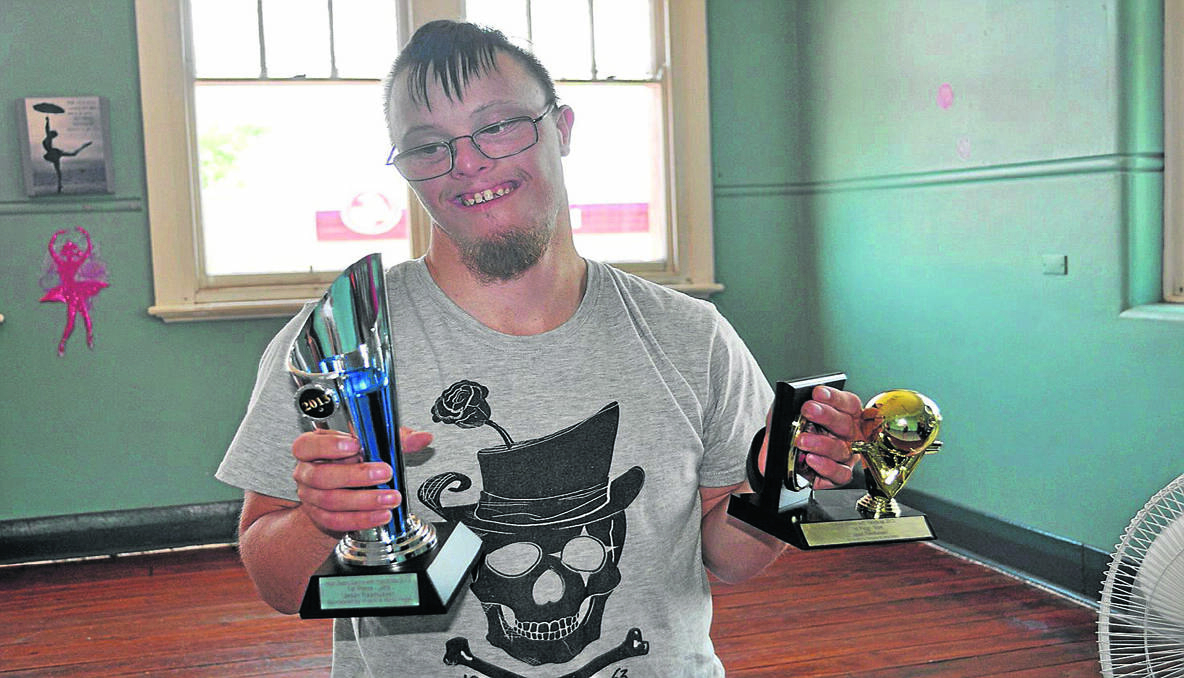 CHAMPION: Jason with his latest swag of ten pin bowling trophies.