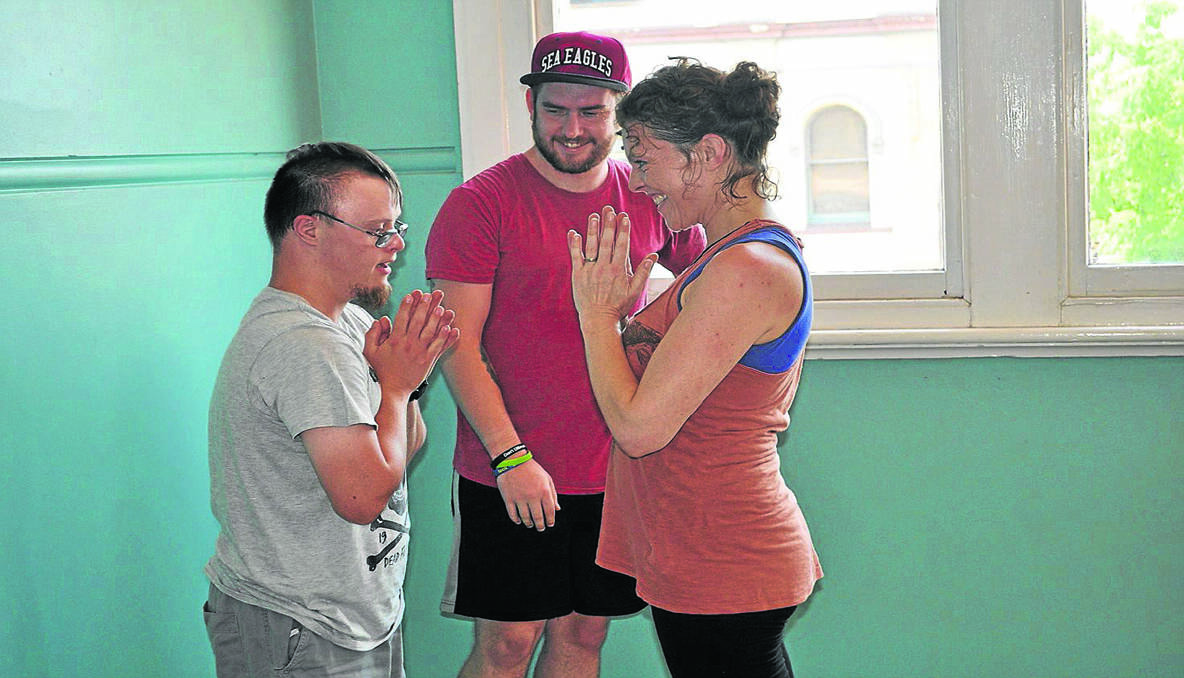 GREAT RESULTS: Jason Rasmussen with his support worker Rory Fennell and yoga instructor Nicky West.