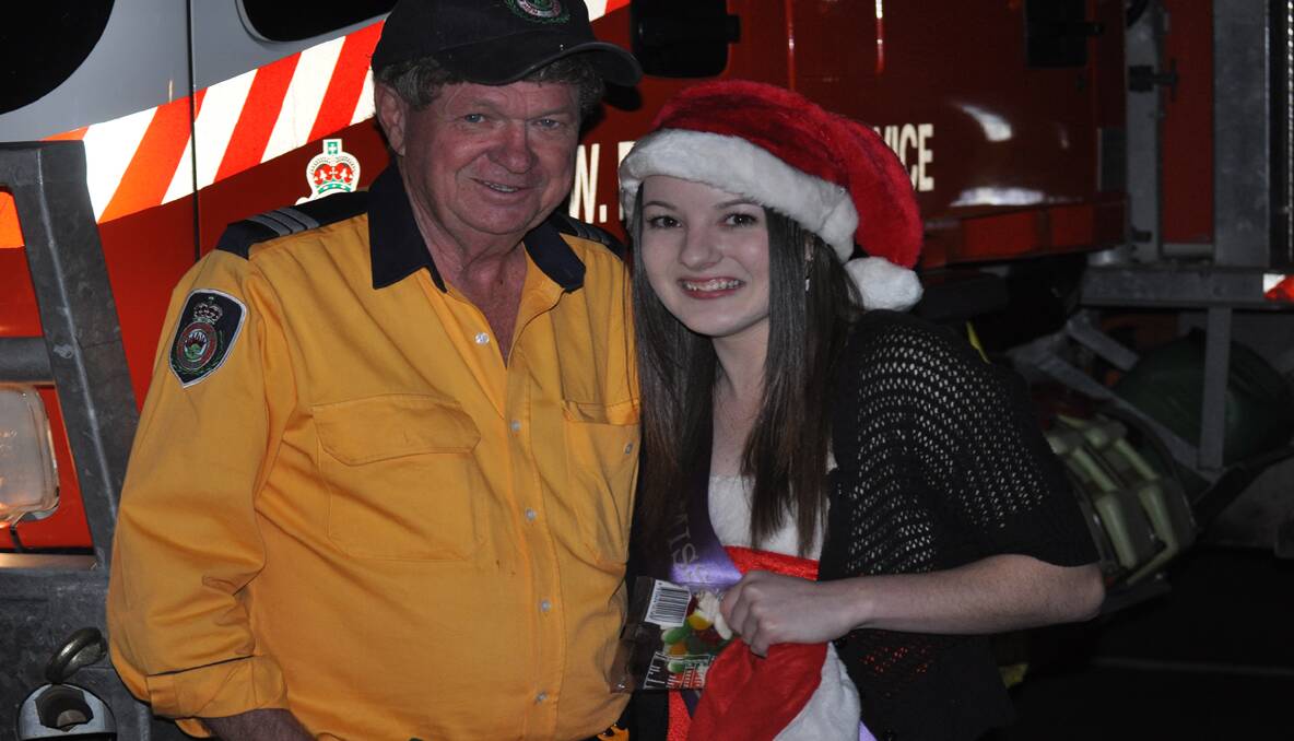 FESTIVE: Les Goldie of the Kearsley Fire Brigade with newly crowned Miss Cessnock, Allyra Robson. 