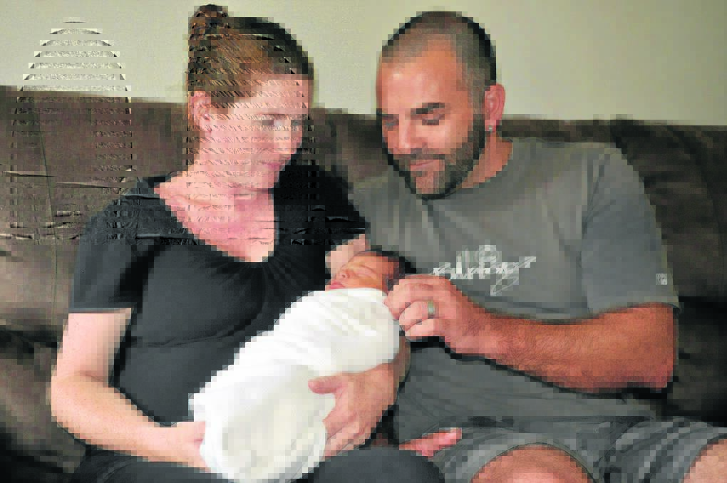 SPECIAL DELIVERY: Amanda and Chris McCarry with baby Kathryn, who was born in their car on Wollombi Road, Bellbird.