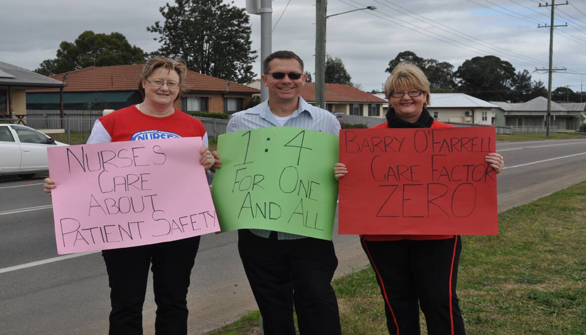 STRIKE: Pictured in Northcote Street, Kurri last week is nurses Brenda Hughes (left) and Sue Gerrish with union secretary Gavin Gaylard, protesting for better patient care.  