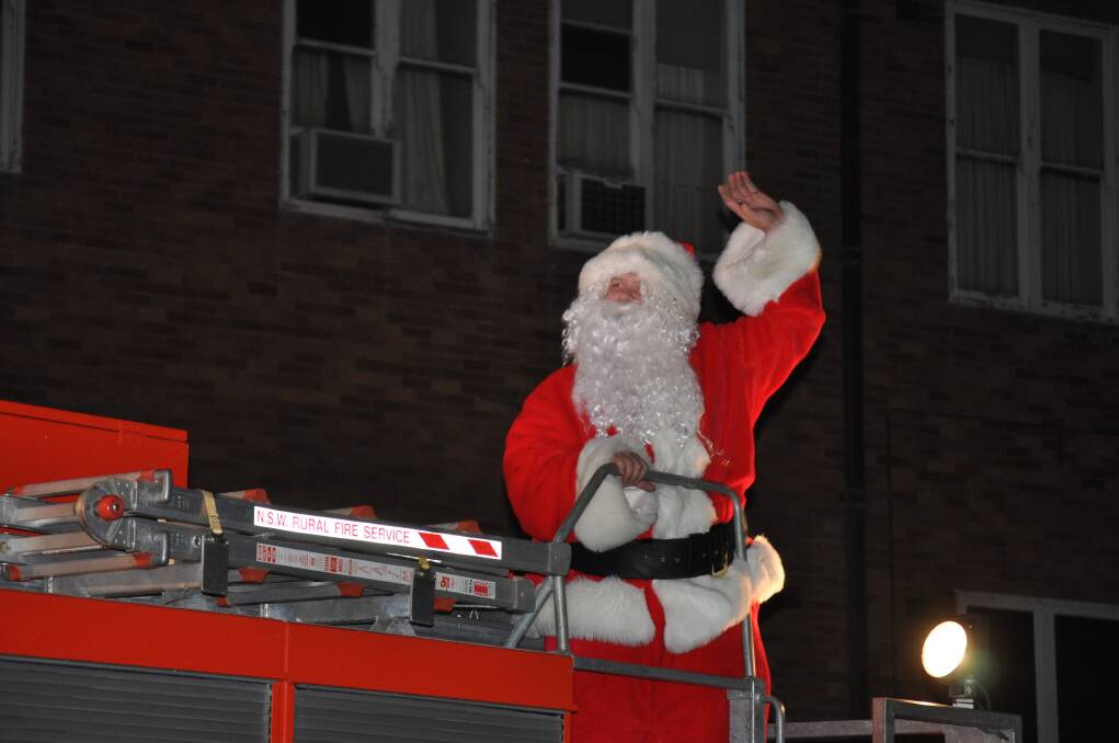 Santa Claus arrives on the back of the Kearsley Fire Brigade truck at Carols in the Park, Cessnock TAFE grounds, December 6.
