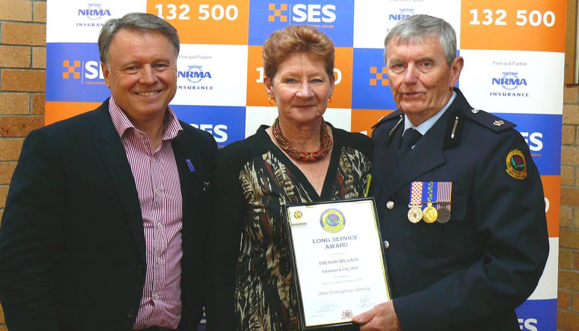 RECOGNITION: Trevor Milgate (right) and his wife Kerry with Member for Hunter Joel Fitzgibb­on at the NSW SES Awards ceremony in Muswellbrook.
