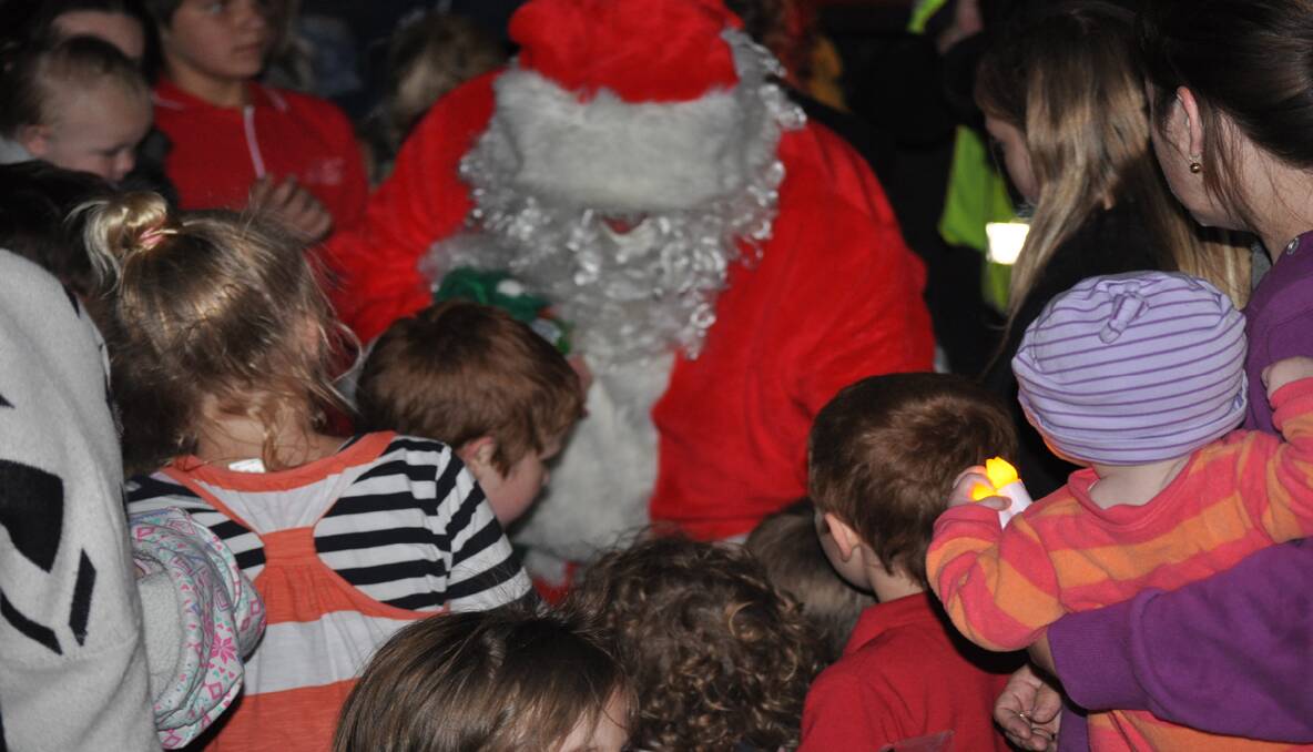 Santa Claus helped hand out lollies to children.