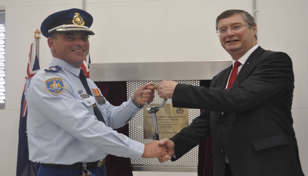 NSW Attorney General and Minister of Justice, the Hon. Greg Smith (right) handing over the keys to Jail General Manager David Mumford. 