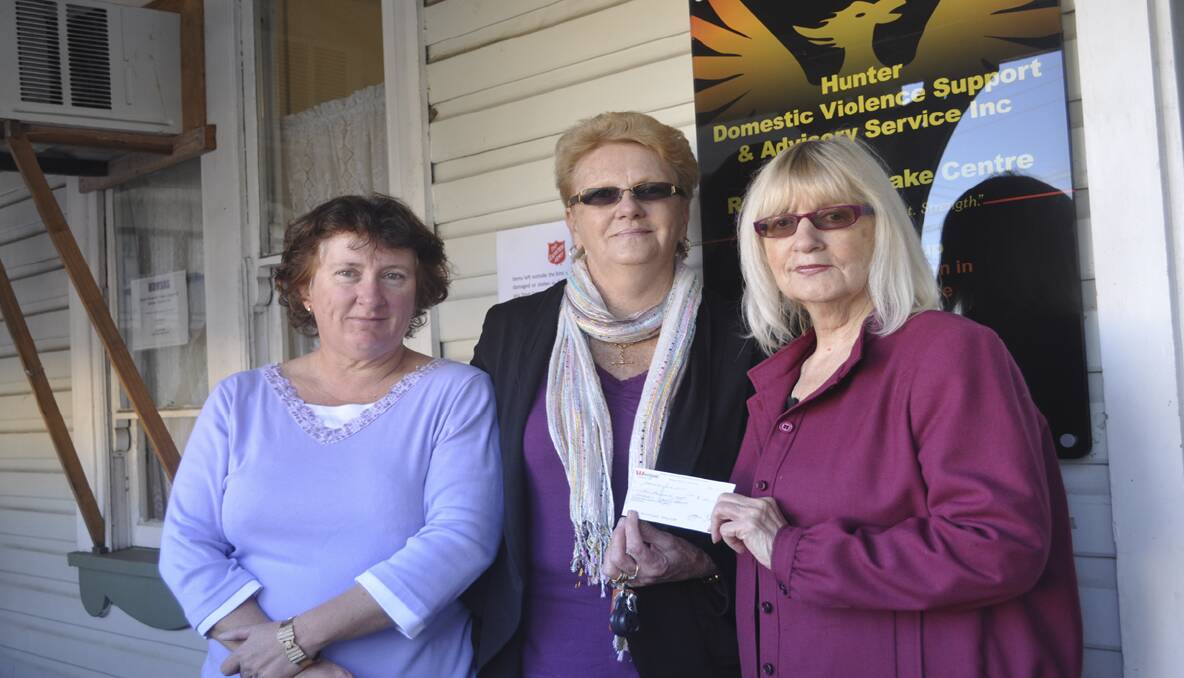 GENEROUS: Cessnock Wine Country Lions Club representative Jan Brien (centre) presents Roxanne and Paula from Hunter Domestic Violence Support and Advisory Services with the cheque to buy a rain water tank for their new refuge.